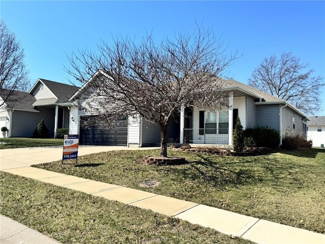 ranch-style home featuring a garage, a front lawn, and driveway