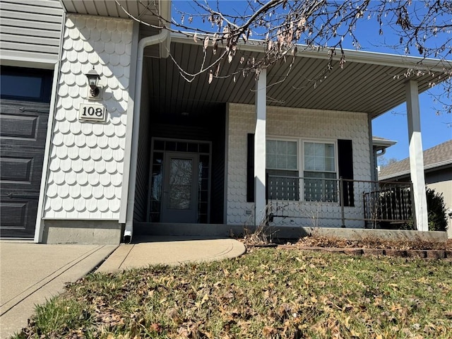 view of exterior entry with a porch