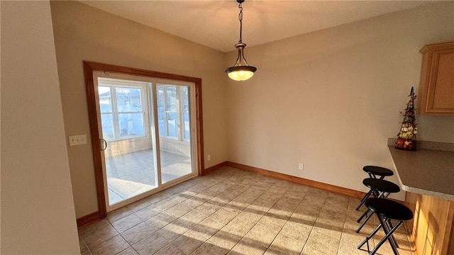 unfurnished dining area featuring baseboards