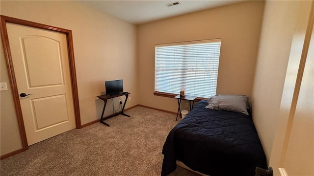 carpeted bedroom featuring baseboards and visible vents