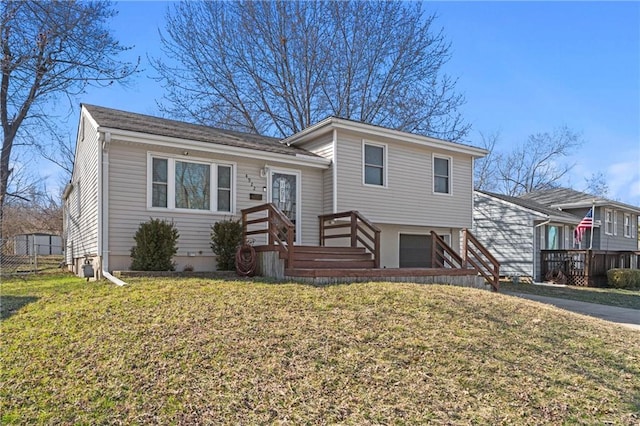 tri-level home with a front lawn, concrete driveway, and a garage