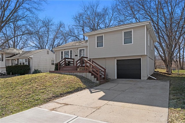 split level home with driveway, an attached garage, and a front yard