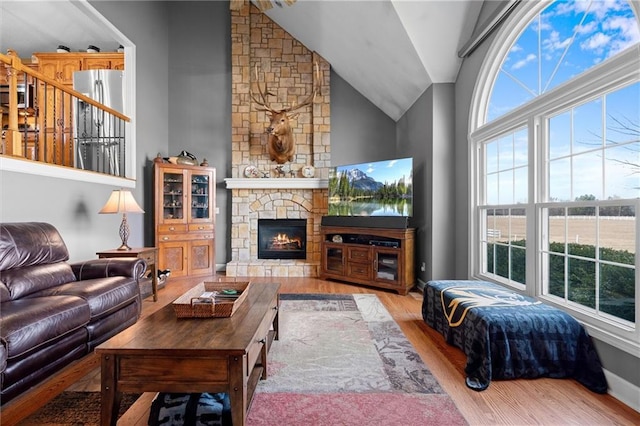 17701 C Hwy, Trimble, MO 64492 - living room with wood finished floors, lofted ceiling, and a stone fireplace