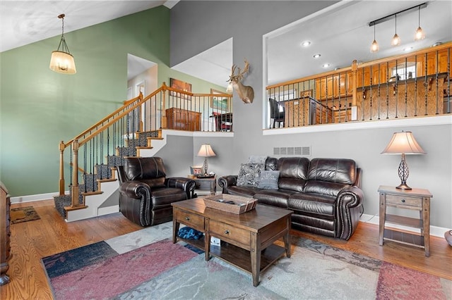 17701 C Hwy, Trimble, MO 64492 - living room featuring wood finished floors, stairs, recessed lighting, and high vaulted ceiling