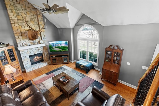 17701 C Hwy, Trimble, MO 64492 - living room with vaulted ceiling, a ceiling fan, wood finished floors, and a stone fireplace