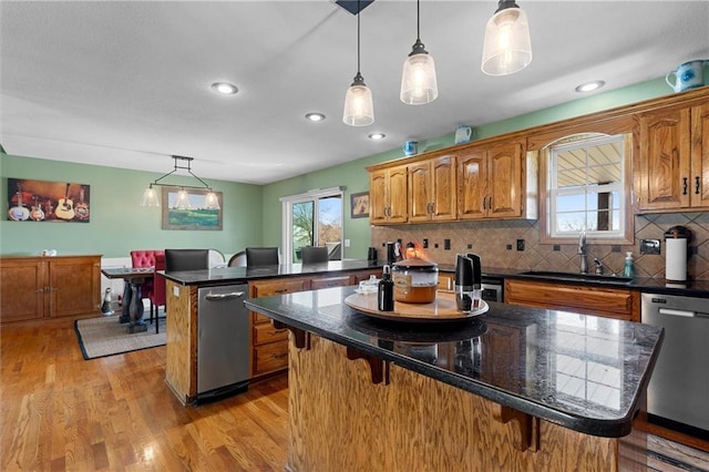 17701 C Hwy, Trimble, MO 64492 - kitchen featuring a peninsula, a breakfast bar, dishwasher, a center island, and brown cabinetry