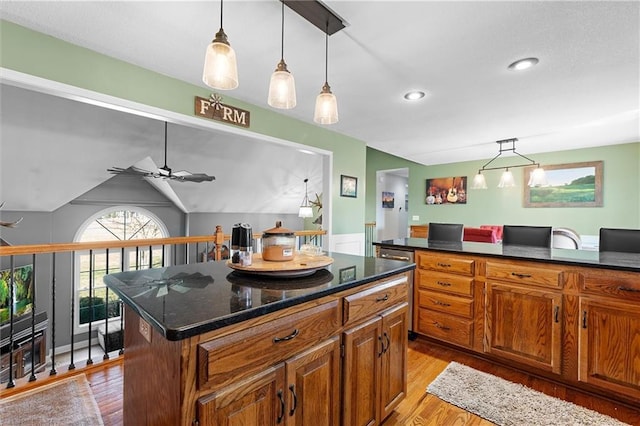 17701 C Hwy, Trimble, MO 64492 - kitchen with light wood-style flooring, brown cabinetry, a ceiling fan, an office area, and a center island