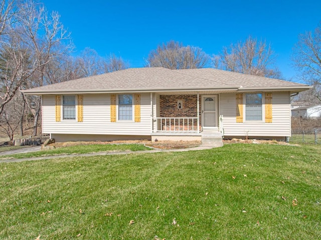 ranch-style home with roof with shingles, a porch, and a front lawn