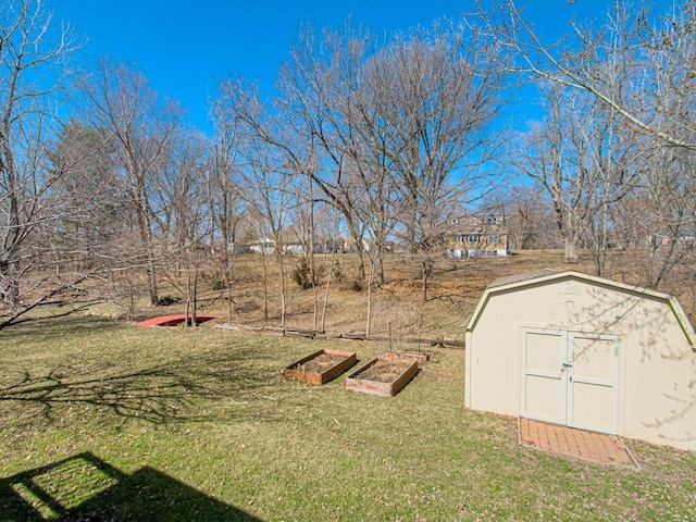 view of yard featuring an outdoor structure, a vegetable garden, and a shed