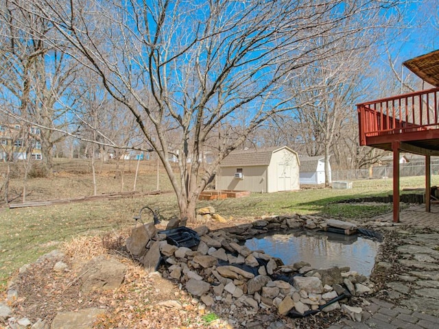 view of yard with a deck, an outbuilding, and a storage unit