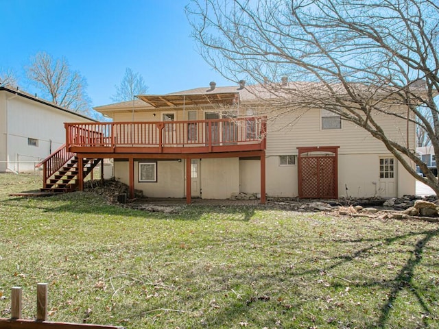 rear view of house with a wooden deck, a lawn, and stairway