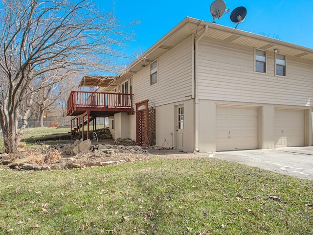 view of home's exterior with stairway, an attached garage, a yard, and a wooden deck