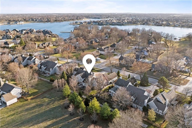 drone / aerial view with a water view and a residential view