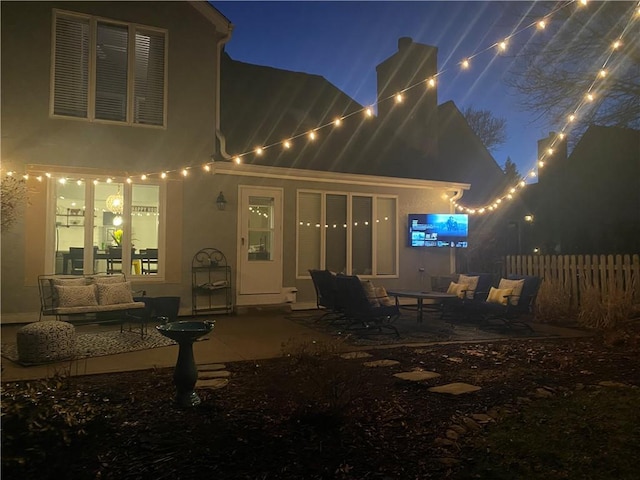 patio at twilight featuring fence