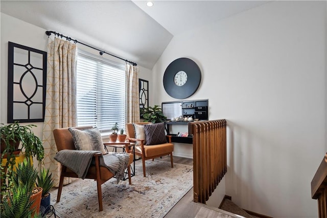 living area featuring lofted ceiling