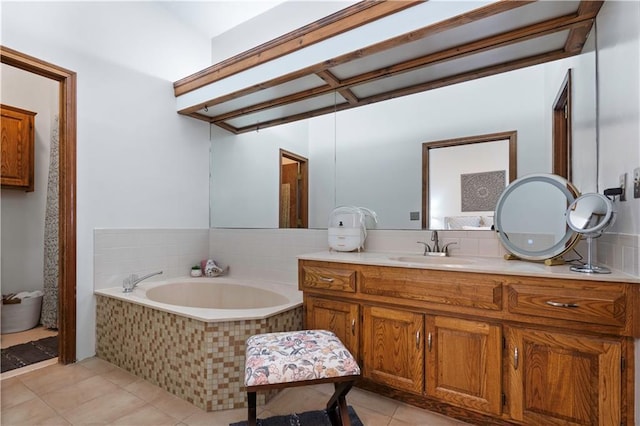 bathroom with tile patterned floors, a bath, and vanity