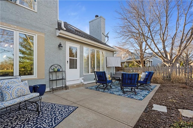 view of patio with an outdoor living space and fence