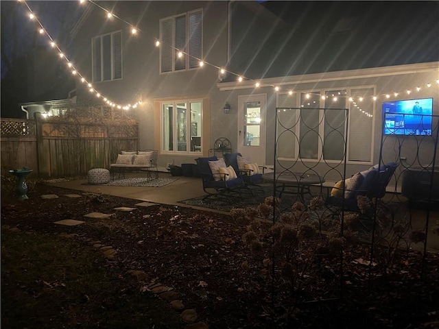 exterior space featuring visible vents, an outdoor living space, fence, stucco siding, and a patio area