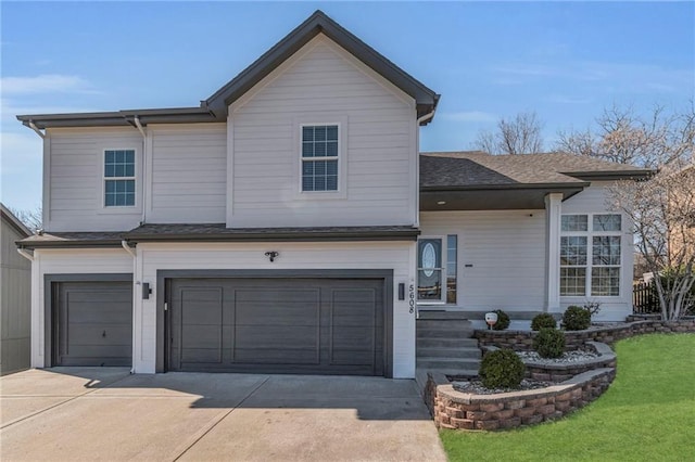 view of front of house with a garage, concrete driveway, a front lawn, and a shingled roof