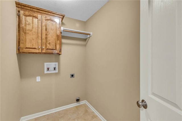 washroom featuring baseboards, hookup for a washing machine, cabinet space, electric dryer hookup, and a textured ceiling