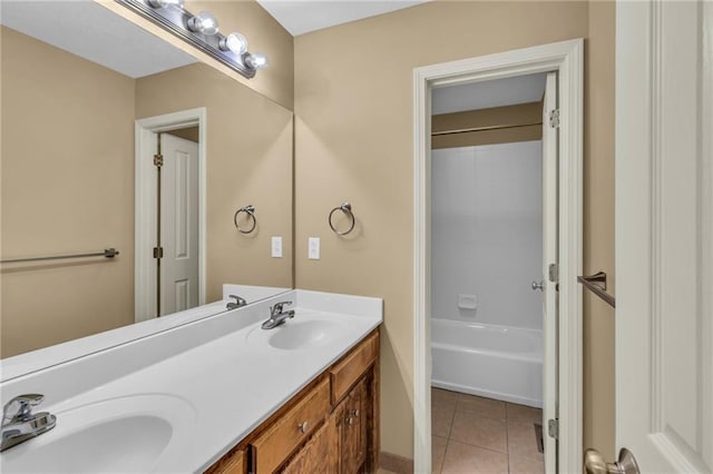 bathroom with tile patterned flooring, shower / washtub combination, double vanity, and a sink