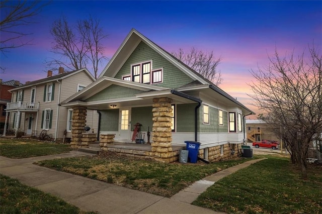 209 High St, Platte City, MO 64079 - view of front of house with central air condition unit, a porch, and a front yard