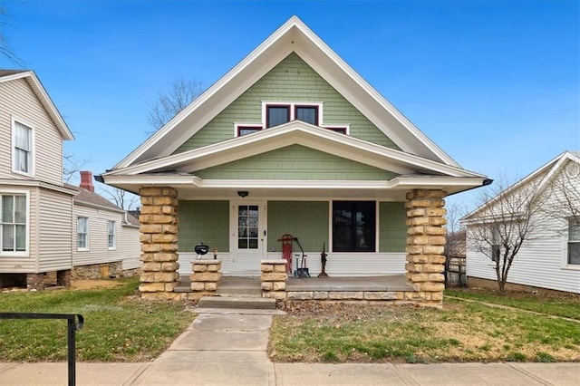 209 High St, Platte City, MO 64079 - view of front facade with a porch and a front lawn