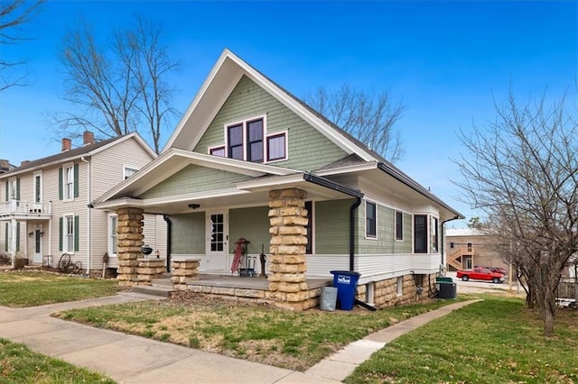 209 High St, Platte City, MO 64079 - view of front of property featuring a front yard, cooling unit, and a porch