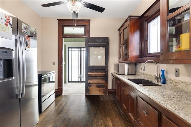 209 High St, Platte City, MO 64079 - kitchen with dark wood-style floors, a ceiling fan, stainless steel appliances, a sink, and glass insert cabinets
