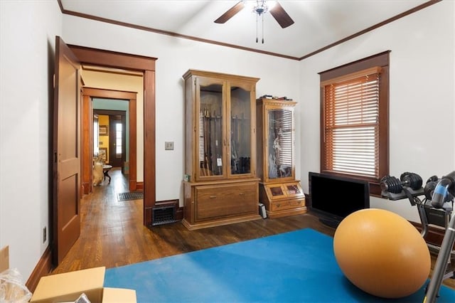 209 High St, Platte City, MO 64079 - exercise area with ceiling fan, baseboards, wood finished floors, and crown molding