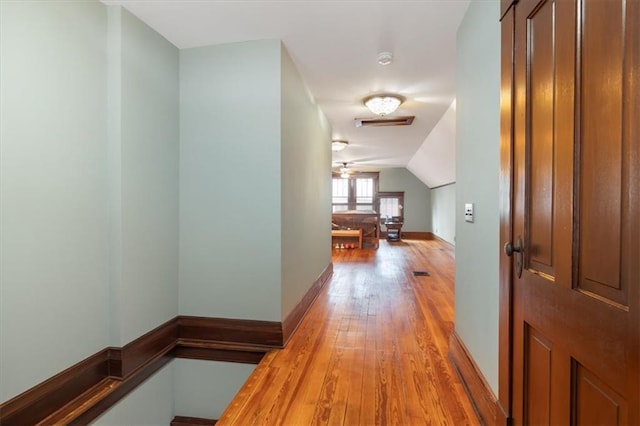 209 High St, Platte City, MO 64079 - hallway with light wood-style flooring, baseboards, and vaulted ceiling