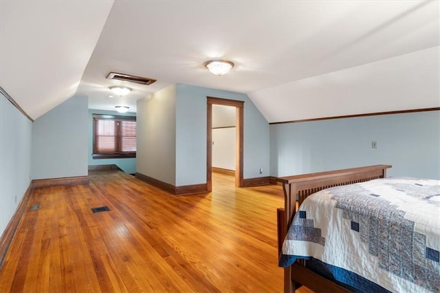 209 High St, Platte City, MO 64079 - bedroom with visible vents, lofted ceiling, baseboards, and hardwood / wood-style floors