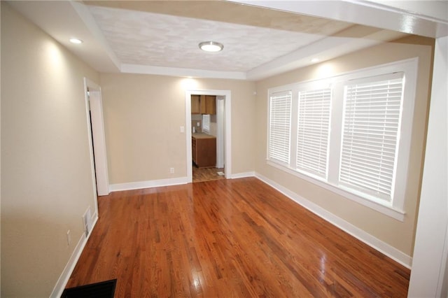 spare room with visible vents, recessed lighting, baseboards, and wood finished floors