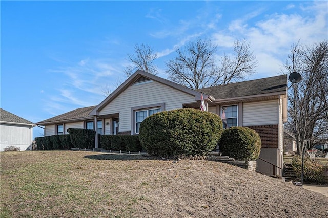 view of front of property with brick siding and a front lawn