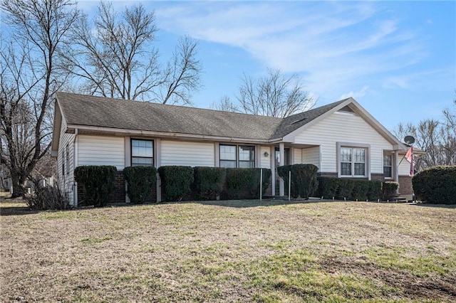 ranch-style home with a front lawn and brick siding