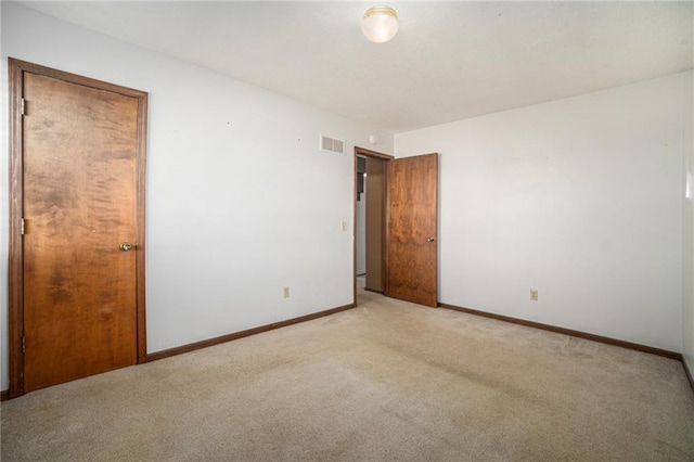 unfurnished bedroom with visible vents, baseboards, and light colored carpet