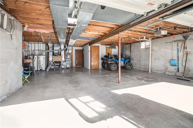 garage featuring a garage door opener and water heater