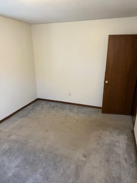 1507 W Concord Dr, Plattsburg, MO 64477 - unfurnished room featuring a textured ceiling, baseboards, and carpet