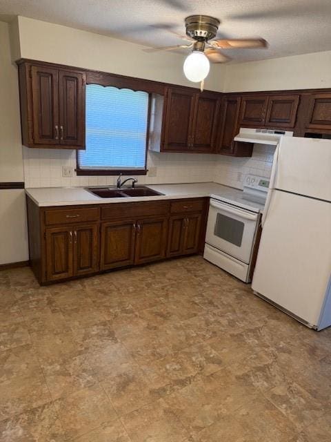 1507 W Concord Dr, Plattsburg, MO 64477 - kitchen featuring white appliances, backsplash, under cabinet range hood, ceiling fan, and a sink