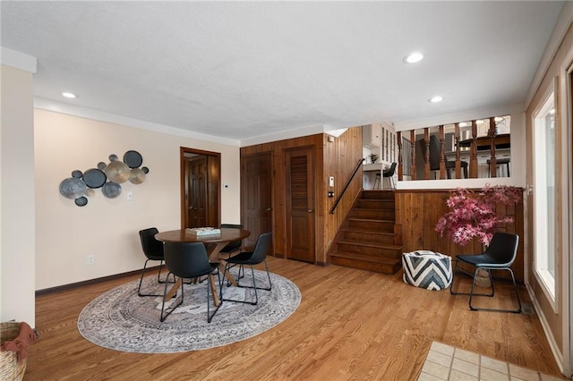 dining room featuring recessed lighting, stairway, baseboards, and wood finished floors