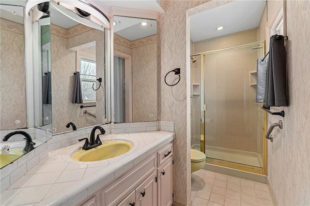 full bath with a shower stall, wallpapered walls, vanity, and toilet