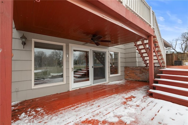 snow covered deck featuring stairs and a ceiling fan