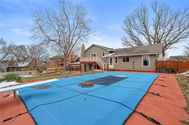 view of swimming pool with a fenced in pool, fence, stairs, a deck, and a patio