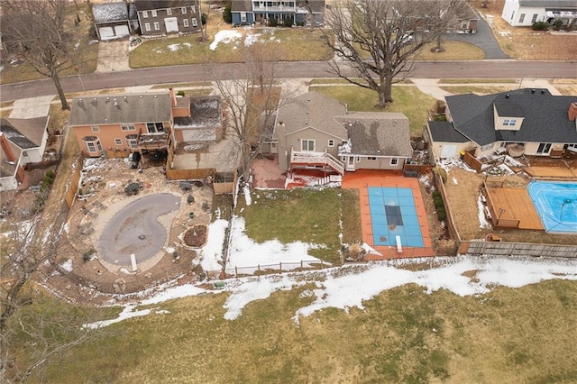 snowy aerial view with a residential view