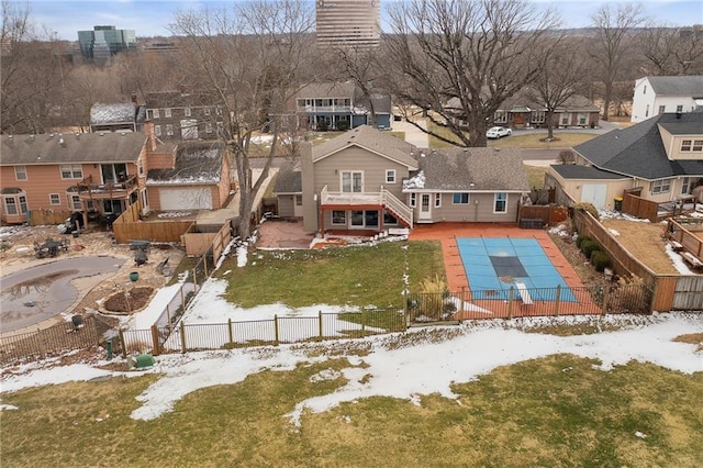 snowy aerial view with a residential view