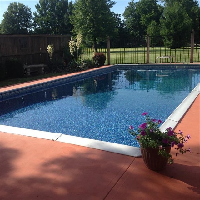 view of pool featuring a patio area, a fenced in pool, and a fenced backyard