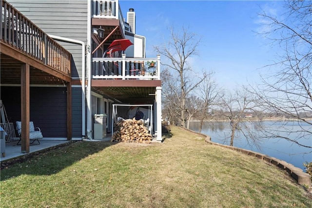 view of yard with a patio and a deck with water view