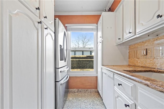 kitchen with white cabinetry, stainless steel fridge, white dishwasher, and ornamental molding