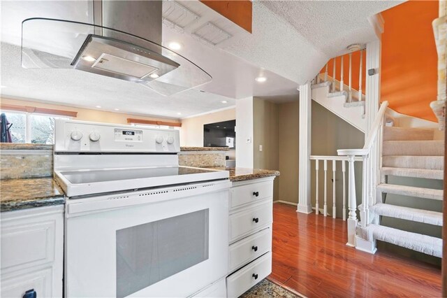 kitchen with white range with electric stovetop, a textured ceiling, white cabinetry, and dark wood-style flooring