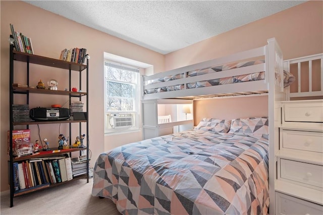 carpeted bedroom featuring cooling unit and a textured ceiling